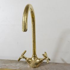 a brass hook with two birds on it