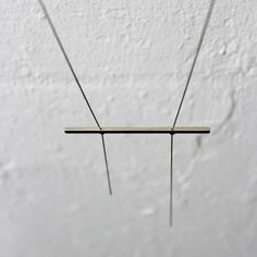 "Minimalist necklace for women, long statement necklace with a horizontal bar pendant, handmade of sterling silver. Beautiful and artistic contemporary jewelry design. Modern and minimalist geometric necklace, handmade of sterling silver. This unique necklace has a simple yet sophisticated look. It features a horizontal bar pendant, hanging on a delicate chain, its edges wider than the chain, and a-symmetrical fringes dangling below it. This modern and minimalist geometric necklace is a fabulous Modern Sterling Silver Bar Necklace, Minimalist Sterling Silver Bar Necklace With Rectangular Pendant, Every Day Necklace, Minimalist Necklace Silver, Minimal Pendant, Necklace Bar, Concrete Jewelry, Contemporary Jewelry Design, Handmade Pendant Necklace