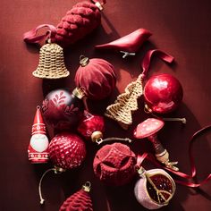 christmas ornaments are arranged on a red surface