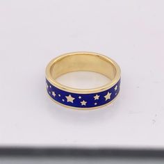 "Enamel ring with stars, gold enamel wedding band, blue enamel ring Sterling silver with a gold vermeil finish and glass enamel. This listing is for the enamel ring only! SHOWN with a moonstone stackable band, for styling purposes. A perfectly deep blue night sky has been captured in this handmade enamel ring, strewn with stars all the way around An eternity ring for your stack, or a wedding band that is uniquely yours, make this ring your signature piece. Sterling silver with a gold vermeil fin Blue Enamel Ring With Polished Finish For Gift, Blue Enamel Ring With Polished Finish As Gift, Blue Enamel Ring With Polished Finish, Blue Enamel Polished Round Ring, Blue Polished Enamel Ring, Gold Enamel Star Jewelry, Blue Enamel Rings For Anniversary, Blue Enamel Round Rings, Luxury Gold Enamel Ring