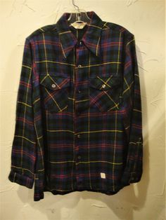 "This is a vintage deadstock wool plaid shirt by Glenbrooke.  It's from the 1950's or 60's.  It features two flap chest pockets and long sleeves.  The fabric is wool with some rayon. It is in excellent condition, clean and ready to wear.  Comes from a smoke free home. Measurements:  Chest:  42\"    Across Shoulder:  16.5\"   Sleeve Length:  24\"   Length from Shoulder to Hem:  28\" Please ask me any questions you may have before buying as this is a final sale. Please know your measurements and a Vintage Plaid Shirt With Pockets, Retro Collared Flannel Shirt With Pockets, Vintage Plaid Flannel Shirt With Pockets, Vintage Flannel Shirt With Pockets, Double Pocket Shirt, Heavy Winter Coat, Pocket Shirt, Wool Plaid, Plaid Shirt