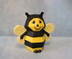 a yellow and black bee figurine sitting on top of a table