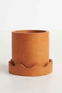 a brown planter sitting on top of a white table