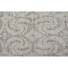 a beige and black rug with an intricate design