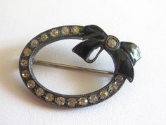 From a FL estate, this brooch is from the Victorian era, black, metal with enamel bow and clear rhinestones.  Strong c-clasp, normal vintage wear.  In good vintage condition. FREE SHIPPING IN THE USA ONLY. Victorian Brooch, Park Lane Jewelry, The Victorian Era, Dragonfly Earrings, Vintage Clip, Black Rhinestone, Vintage Wear, Round Earrings, 1960s Vintage