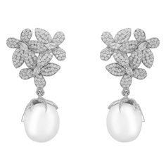 Make an unforgettable fashion statement this season with the breath-taking Flowers Pearl Earrings. These exquisite earrings showcase a timelessly sophisticated floral-inspired design that will bring out your unique beauty and charm. Three delicate blossoms set as if in a bouquet boast an abundance of dazzling cubic zirconia on each petal with a beautiful pearl dangling provocatively beneath, giving it an extra special touch of sophistication. This timeless gemstone will take you to every signifi Stylish Bride, Baroque Pearl Earrings, Unique Beauty, Mens Jewelry Bracelet, Silver Flowers, Heart Jewelry, Baroque Pearls, Everyday Wardrobe, Birthstone Jewelry