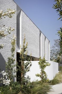 an exterior view of a building with trees and bushes