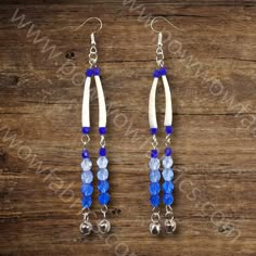 blue and white beaded earrings with bells on wooden background photo - free image about jewelry