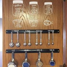 a wooden cabinet with measuring spoons and measuring cups on it