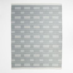 a gray and white rug with lines on it