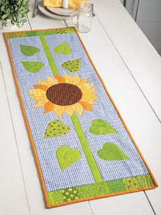 a table runner with a sunflower on it