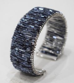 a close up of a bracelet on a white surface