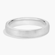 a white gold wedding ring with a thin band on the outside and a slight edge