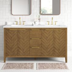 a bathroom vanity with two mirrors above it