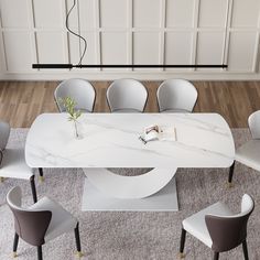 a white marble table surrounded by chairs and a vase with a plant on it, in front of a paneled wall