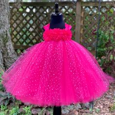 Fuzzy Duckling Design dresses ~ handcrafted for the little princess in your life. Watch your little one sparkle in this beautiful princess dress! This gorgeous dress features a stretchy, crocheted bodice that is fully lined for both comfort and modesty. The full skirts sparkle and shine with three layers of high quality tulle in matte, shimmer, and a sparkle dot finish. Satin ribbon straps and a floral bodice make this dress something extra special. This gown is perfect for birthdays, weddings, Christmas Princess Dress In Pink, Pink Tulle Tutu Dress For Christmas, Pink Christmas Pageant Dress, Pink Ruffled Tutu Dress For Christmas, Polka Dot Princess Dress For Party, Cute Pink Tutu Dress For Christmas, Pink Ruffled Christmas Tutu Dress, Princess Style Polka Dot Party Dress, Pink Christmas Tutu Dress With Ruffles