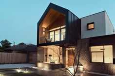 a modern house is lit up at night