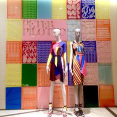 two mannequins dressed in colorful clothing standing next to each other