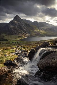 a small waterfall running down the side of a mountain