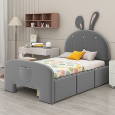 a child's bed with an elephant head on the side and two nightstands next to it