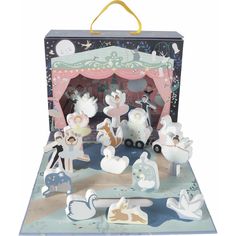 an open suitcase with figurines in it on a white background and some decorations