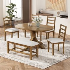 a dining room table with four chairs and a bench