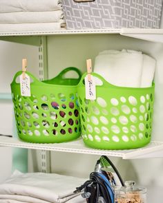 two green laundry baskets sitting next to each other on top of a white shelving unit