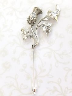 "Beautiful silver Scottish thistle lapel pin / stick pin. Perfect for your Scottish woodland wedding or to celebrate everyday. Show your Scottish heritage. A great alternative to fresh flowers for the men in your wedding party and a great keepsake. Stick pin measures 3 1/2\" long x 1 3/4\" wide and is silver plated brass. This piece can be used as a lapel pin for men or a stick pin for women. Choose from the drop-down how you would like yours packaged. Your order will be shipped in three busines Classic Silver Wedding Pins, Silver Flower Pins For Wedding, Silver Flower Wedding Pins, Silver Brooch Lapel Pin For Wedding, Silver Wedding Lapel Pin, Wedding Bridal Hair, Gift Box For Men, Bridal Hair Accessory, Bridesmaids Photos