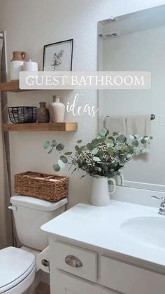 a white toilet sitting next to a bathroom sink under a mirror with the words guest bathroom ideas above it