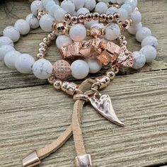 Boho Blush Bracelet Stack – where the enchanting hues of rose gold and pristine white hues come together in a whimsical dance of elegance and boho charm. This stack isn't just jewelry; it's a serenade to your free-spirited soul. Treat yourself with the Boho Blush Stack and let each bracelet tell a tale of carefree grace. So Pretty!! Wear them all on one wrist and stack 'em up or wear 3 on one wrist and two on the other with a watch! Lead & Nickel Free Bracelets are 'one size fits most' and are designed to fit wrists up to 7.5" comfortably Stretch bracelets set of 5 Off White and Rose Gold Hues Pave Crystal Embellishment Heart Charm with Leather Fringe Pull Please be aware that due to the unique and handmade nature of each product, colors, shapes, and bead sizes may vary slightly from the p Feminine Adjustable White Jewelry, Feminine White Adjustable Jewelry, Adjustable Feminine Bangle Bracelet, Feminine Adjustable Bangle Bracelet, Adjustable Spiritual Rose Gold Jewelry, Elegant Rose Gold Hand Wrapped Jewelry, Rose Gold Stackable Beaded Bangle Bracelets, Rose Gold Bohemian Bracelet As Gift, Bohemian White Bangle Jewelry