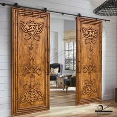 two wooden doors with designs on them