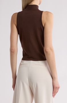 This sleeveless top in an easy, figure-hugging fit is an excellent addition to your chill-time wardrobe. Mock neck Sleeveless 75% rayon, 25% nylon Dry clean Imported Brown Stretch Sleeveless Tank Top, Fitted Sleeveless Knit Camisole, Fitted Knit Sleeveless Camisole, Fitted Knit Sleeveless Blouse, Stretch Knit Vest Top, Seamless Sleeveless Top For Fall, Solid Color Sleeveless Top For Layering, Fitted Sleeveless Tank Top For Fall, Seamless Sleeveless Tank Top For Fall