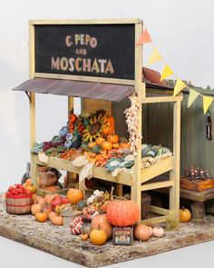 there is a display of vegetables and fruits on the table with a sign that says c pepo and moschata