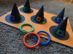 the witches hat tossers are on top of an orange board with black rings and colored foam