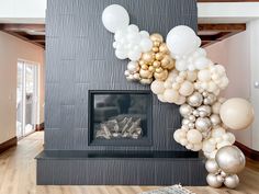 a fireplace decorated with balloons and streamers