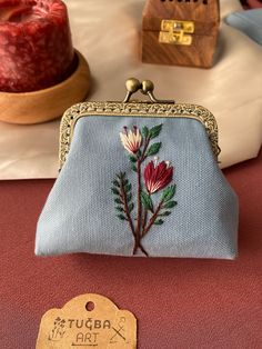 a blue purse sitting on top of a table next to a wooden box with a tag