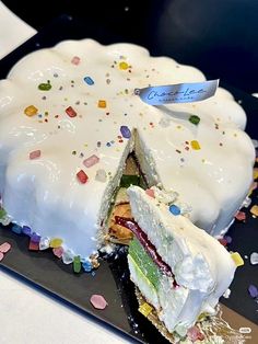 a cake that has been cut in half and is on a plate with confetti