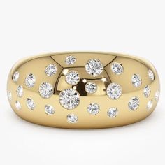 a yellow gold ring with diamonds on it