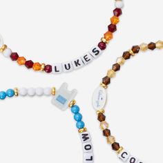 two beaded necklaces with words on them and beads that spell out the word love