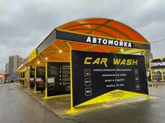 an orange and black car wash station with neon lights