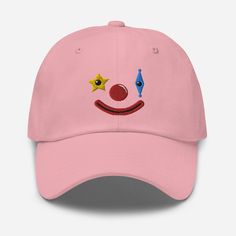 Embroidered clown dad hat!  * 100% chino cotton twill * Green Camo color is 35% chino cotton twill, 65% polyester * Unstructured, 6-panel, low-profile * 6 embroidered eyelets * 3 ⅛" (7.6 cm) crown * Adjustable strap with antique buckle * Blank product sourced from Vietnam or Bangladesh This product is made especially for you as soon as you place an order, which is why it takes us a bit longer to deliver it to you. Making products on demand instead of in bulk helps reduce overproduction, so thank Fun Cotton Hats For Streetwear, Fun Adjustable Cotton Dad Hat, Fun Cotton Visor Hat, Fun Streetwear Dad Cap, Fun Dad Hat For Streetwear, Fun Cotton Trucker Hat, Fun Cotton Snapback Trucker Hat, Fun Cotton Snapback Baseball Cap, Fun Cotton Hat With Curved Bill