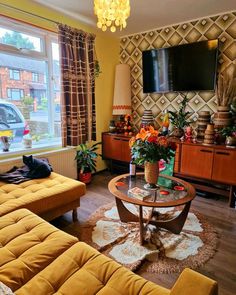 a living room filled with furniture and a flat screen tv