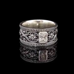 a silver ring with skulls on it