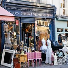 an outdoor furniture store with lots of different items on display in front of the store