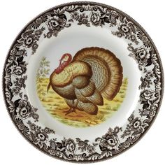 a plate with a turkey painted on the front and sides in black, white and gold