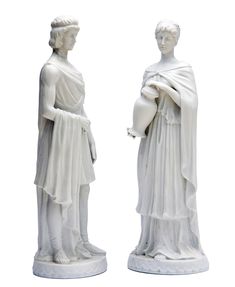 two white marble statues of people standing next to each other