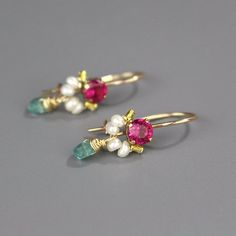 Pink Petite Earrings, Bridesmaid Earrings, Pearl Bridesmaid Jewelry, Whimsical Earrings, Pearl Earrings, Pearl Birthstone, Gift IdeasThese handcrafted dancer earrings are petite, delicate and whimsical. The unique copper bezel setting showcases a bright pink corundum zircon stone. Beautiful and elegant pearls are hand woven and a lovely apatite gemstone dangles gently. These romantic and colorful dancer earrings seem to come straight from a fairytale!They're the perfect pair of earrings to give Fine Jewelry Birthstone Earrings For Wedding, Delicate Birthstone Earrings For Wedding, Dangle Birthstone Earrings For Wedding, Pink Wedding Earrings With Birthstone, Wedding Birthstone Dangle Earrings, Wedding Birthstone Drop Earrings, Exquisite Cluster Drop Earrings For Gifts, Exquisite Gift Cluster Drop Earrings, Whimsical Earrings