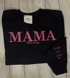 Super cute Embroidered Mom T-shirt or sweatshirt  Listing is for long sleeve t-shirt, hoodie, or sweatshirt You can pick thread color.  You can pick color of shirt (Red, blue, gray, light pink, hot pink, white, black) If no shirt color is picked, default is pink thread with black shirt. PLEASE list kids name in box, the year you became a mom, shirt color and thread color Super cute gift for christmas, birthdays, mothers day etc.  The name on sleeves will be on the left sleeve, with a heart at th Pink Thread, Gray Light, Gift For Christmas, Cute Gift, Mom Shirt, Embroidered Shirt, Kid Names, Shirt Color, Blue Gray