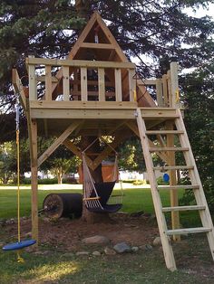 a wooden play structure with a ladder and sign that says interest