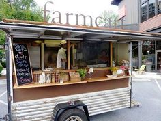 a food truck parked in front of a building with a sign that says farmer's